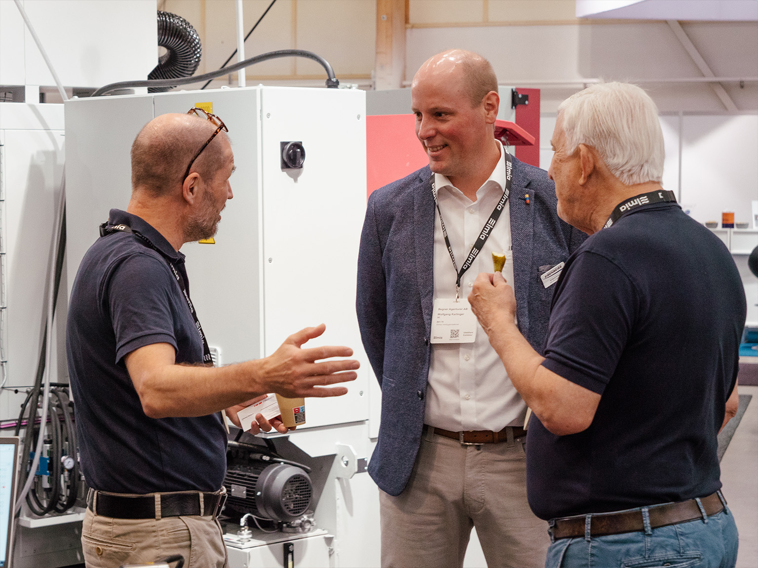 Patrik Fredriksson, Björn Begner, and Wolfgang Karlinger discussing in the booth at Elmia Machine Tools 2024